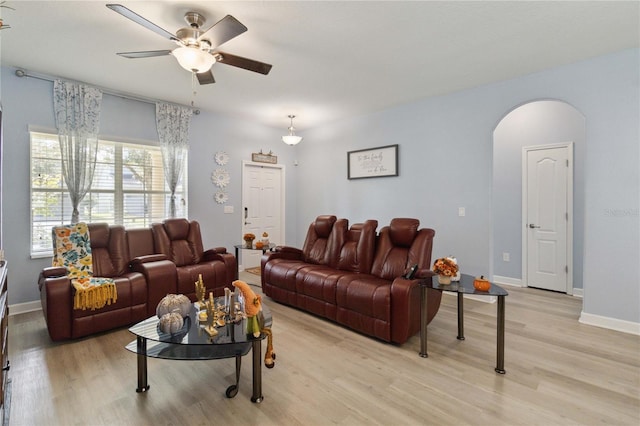 living room featuring ceiling fan and light hardwood / wood-style flooring