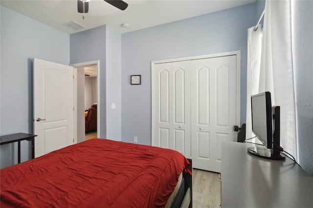 bedroom with ceiling fan, a closet, and light wood-type flooring