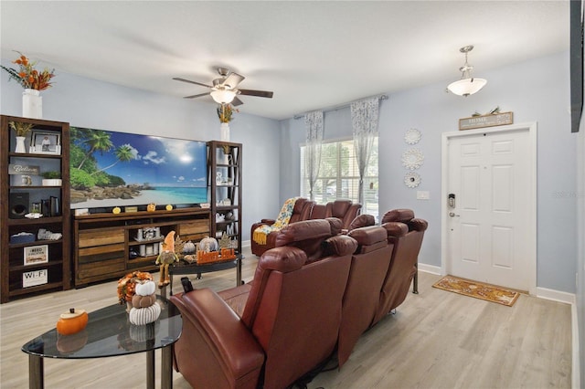 living room featuring ceiling fan and light hardwood / wood-style flooring