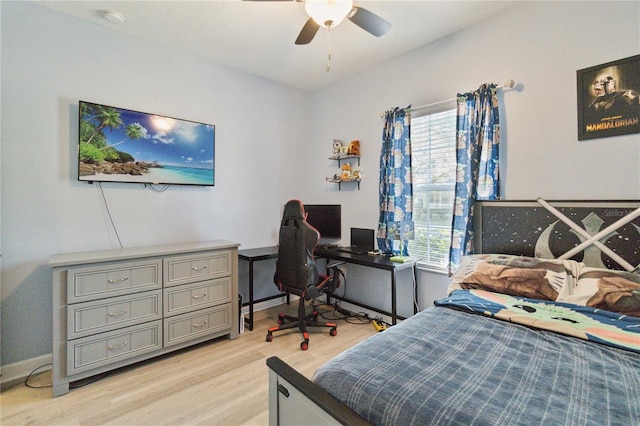 bedroom featuring ceiling fan, light hardwood / wood-style floors, and multiple windows