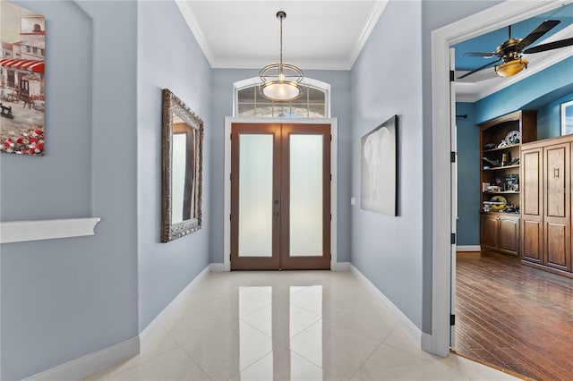 foyer entrance featuring ceiling fan, light hardwood / wood-style floors, crown molding, and french doors