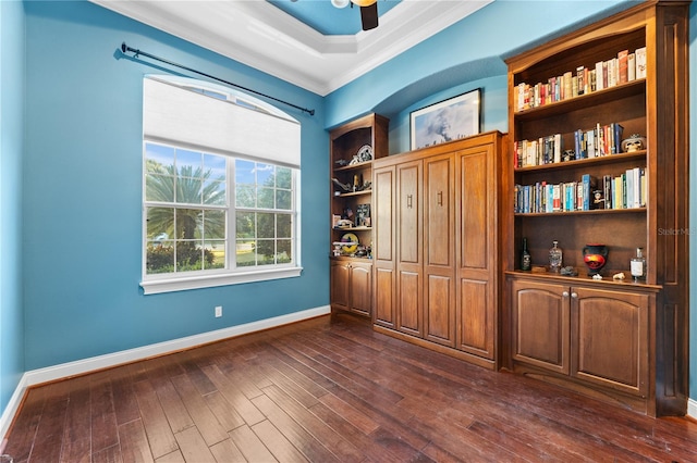 unfurnished office featuring crown molding, ceiling fan, and dark wood-type flooring