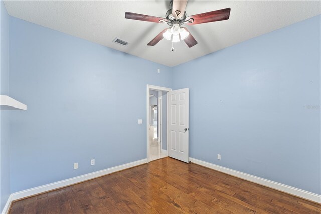 spare room featuring ceiling fan, hardwood / wood-style floors, and a textured ceiling