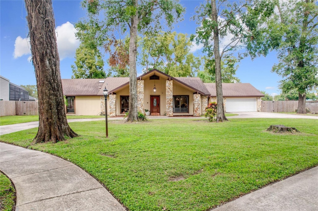 view of front of property featuring a garage and a front lawn