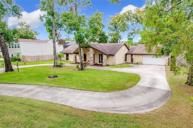 view of front facade with a garage and a front lawn