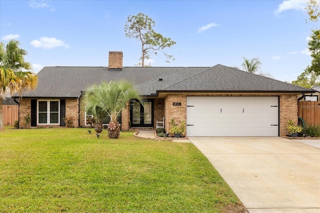 ranch-style home featuring a garage and a front lawn