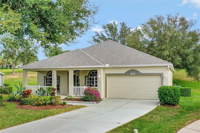 ranch-style home featuring covered porch, a garage, and a front yard