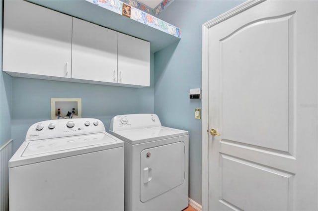 washroom featuring cabinets and washing machine and clothes dryer