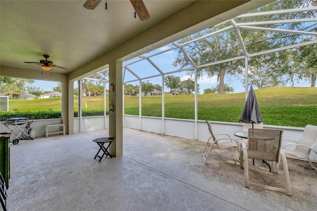 sunroom featuring ceiling fan