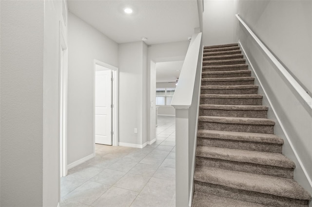 staircase with tile patterned floors