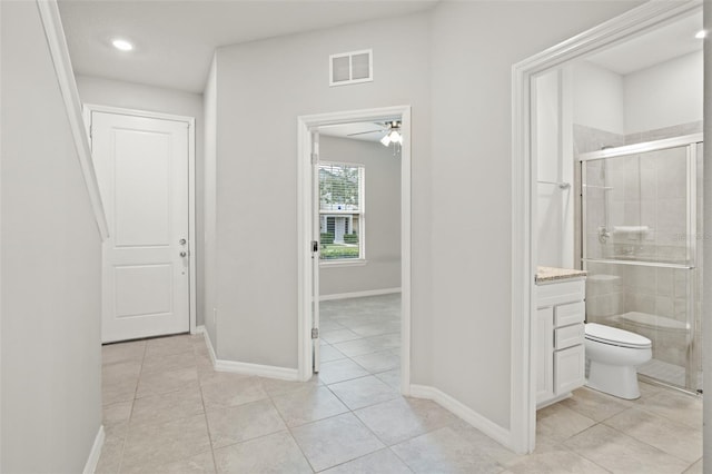 corridor featuring light tile patterned floors