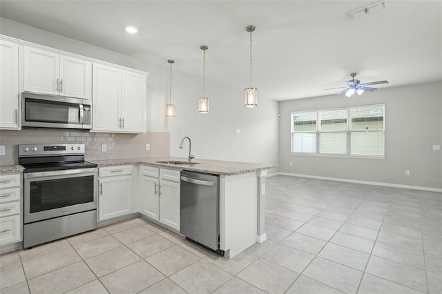 kitchen with ceiling fan, sink, hanging light fixtures, white cabinets, and appliances with stainless steel finishes