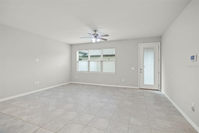 tiled spare room with ceiling fan