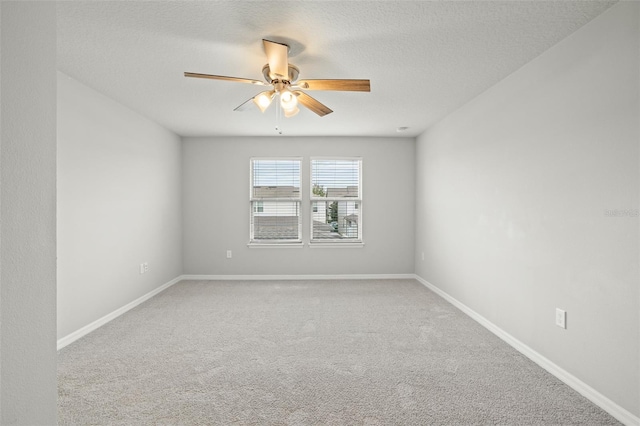 carpeted spare room with ceiling fan and a textured ceiling