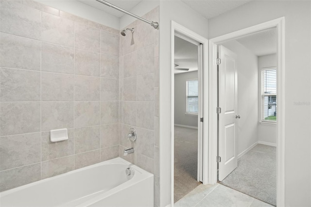 bathroom with tile patterned floors and tiled shower / bath