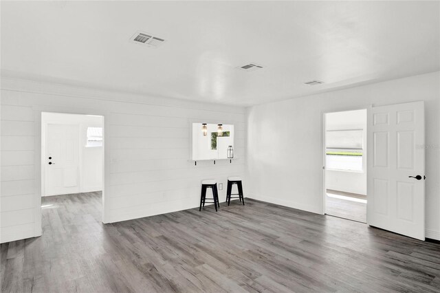 5305 S Ridgewood Ave, Port Orange, FL 32127 - unfurnished living room with wood finished floors, plenty of natural light, and baseboards