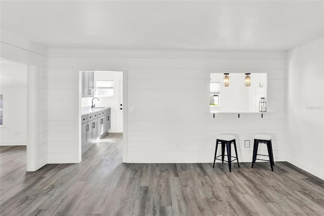 5305 S Ridgewood Ave, Port Orange, FL 32127 - empty room featuring a sink, wood finished floors, and baseboards