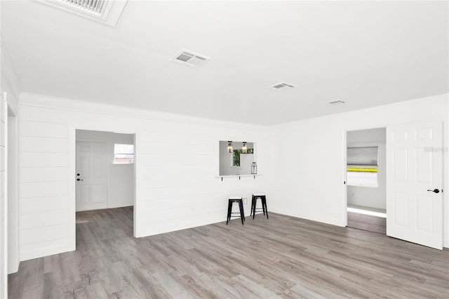 5305 S Ridgewood Ave, Port Orange, FL 32127 - unfurnished living room with wood finished floors and ornamental molding