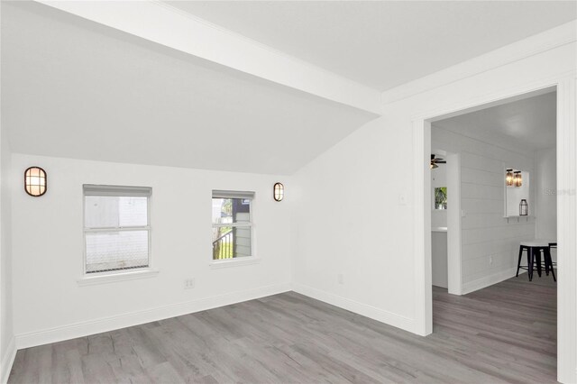 5305 S Ridgewood Ave, Port Orange, FL 32127 - empty room featuring wood finished floors, vaulted ceiling, and baseboards