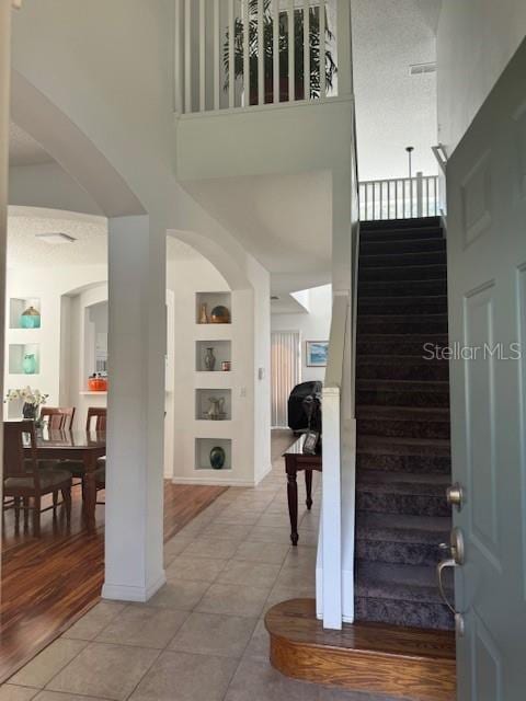 tiled entrance foyer featuring a high ceiling