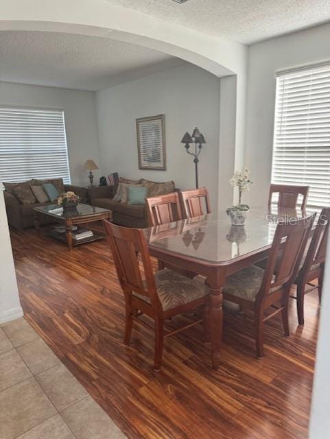 dining room with light hardwood / wood-style flooring and a textured ceiling