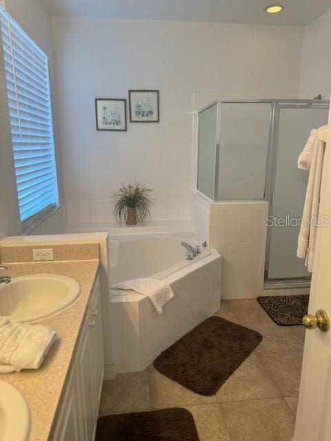 bathroom featuring tile patterned flooring, vanity, and separate shower and tub