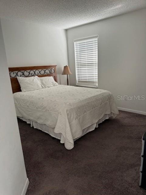 carpeted bedroom featuring a textured ceiling