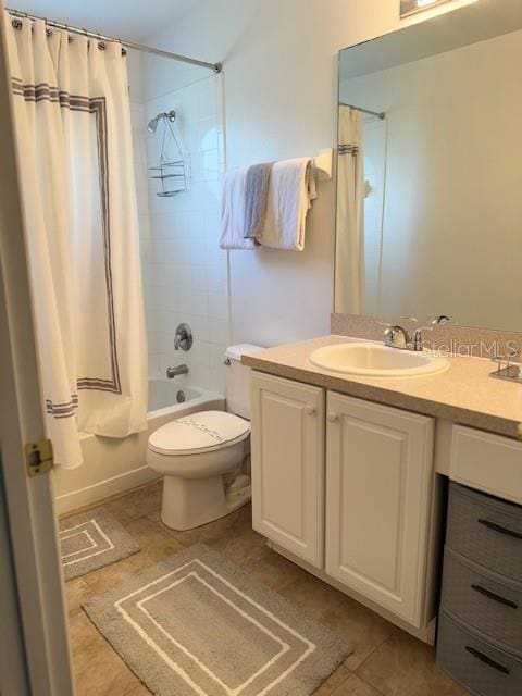 full bathroom featuring tile patterned flooring, vanity, toilet, and shower / bathtub combination with curtain