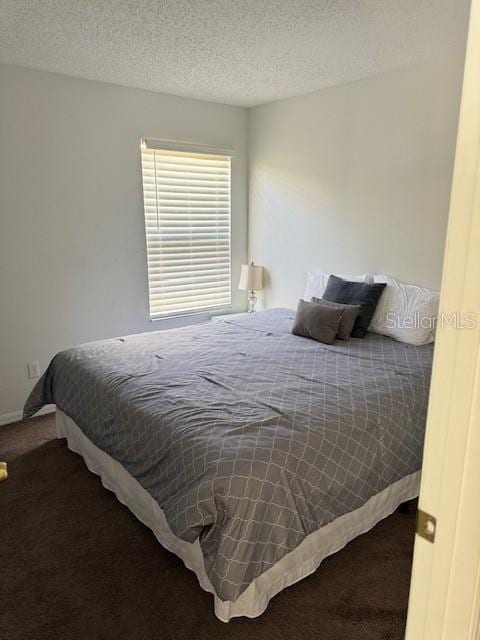 bedroom with carpet flooring and a textured ceiling