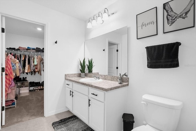 bathroom with tile patterned floors, vanity, and toilet