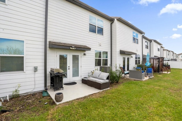 back of house featuring french doors, an outdoor hangout area, a patio area, and a yard