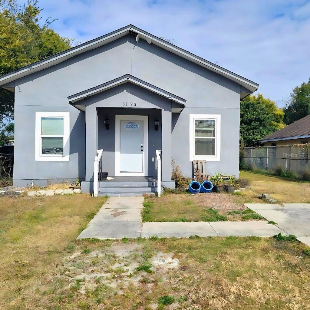 bungalow-style home featuring a front yard