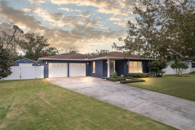 view of front facade featuring a yard and a garage