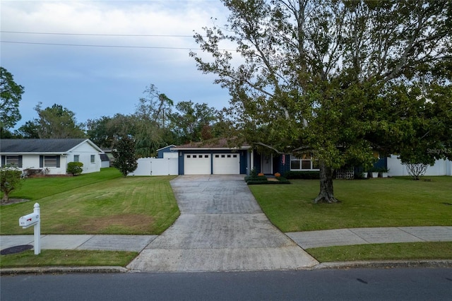 single story home featuring a front yard and a garage