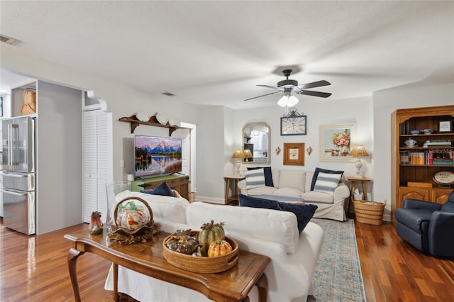 living room with wood-type flooring and ceiling fan