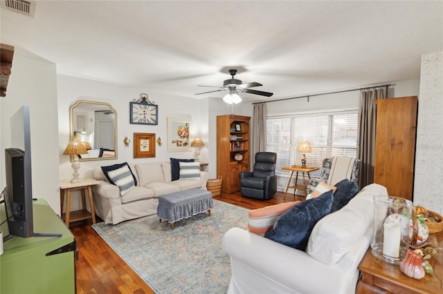 living room featuring ceiling fan and dark hardwood / wood-style floors