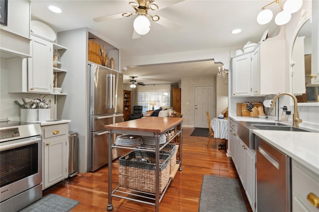 kitchen featuring dark wood-type flooring, white cabinetry, sink, and stainless steel appliances