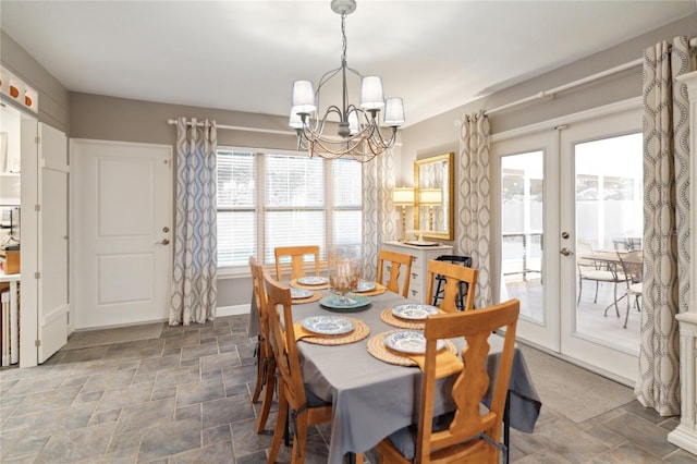 dining room with a chandelier and french doors