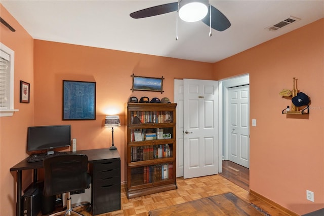 office with light parquet flooring and ceiling fan