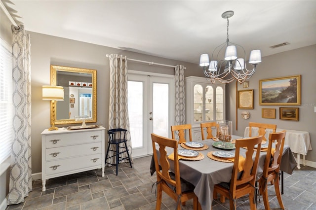 dining room featuring a chandelier and french doors