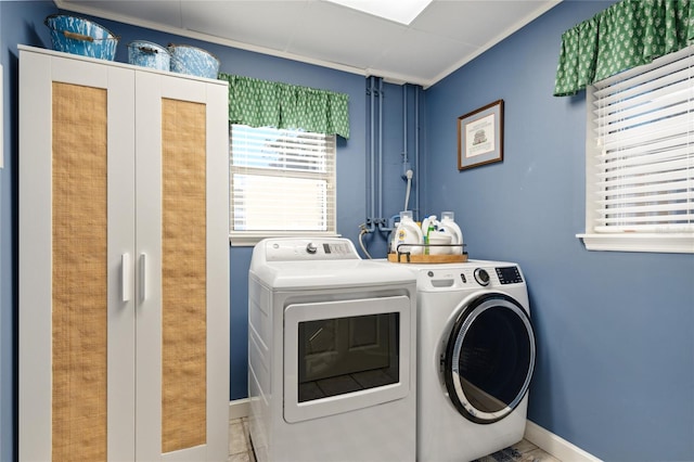 washroom with washing machine and clothes dryer