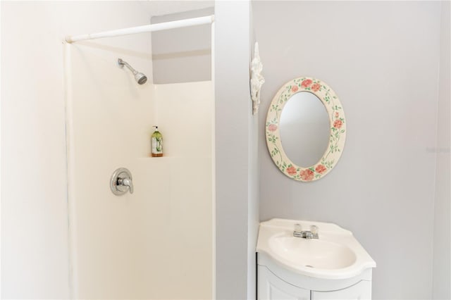 bathroom with a shower and vanity