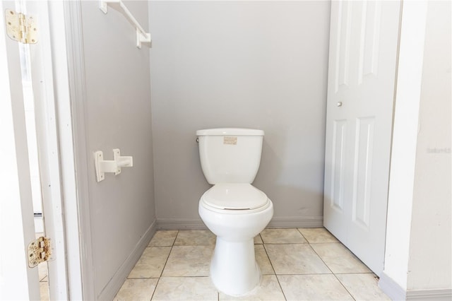 bathroom featuring baseboards, toilet, and tile patterned floors