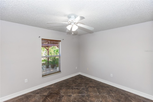 unfurnished room featuring a textured ceiling, ceiling fan, and baseboards