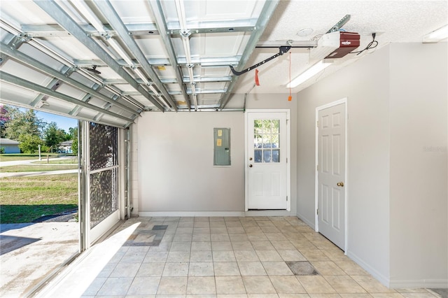 garage with baseboards, electric panel, and a garage door opener