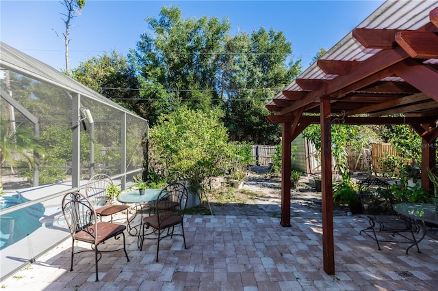 view of patio with glass enclosure, a fenced backyard, and a pergola