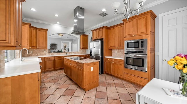 kitchen with a center island, ornamental molding, appliances with stainless steel finishes, decorative light fixtures, and island exhaust hood