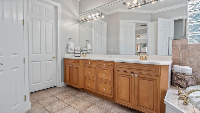 bathroom with tile patterned floors, vanity, ceiling fan, and crown molding