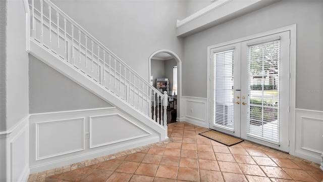 tiled entryway featuring french doors