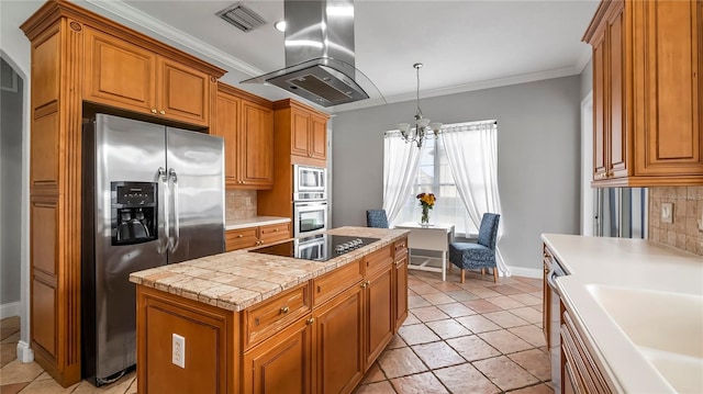 kitchen featuring backsplash, crown molding, a notable chandelier, island exhaust hood, and stainless steel appliances